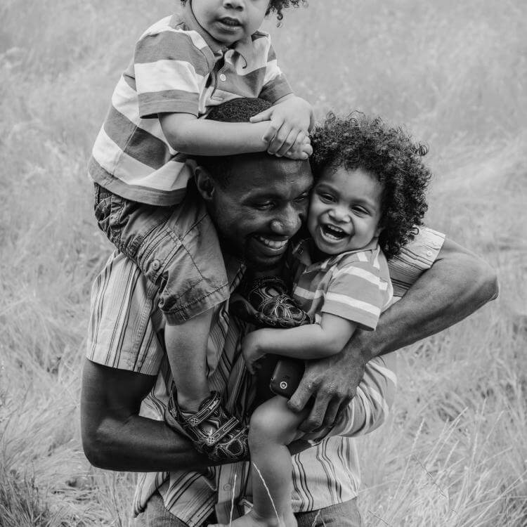 Man holding two children