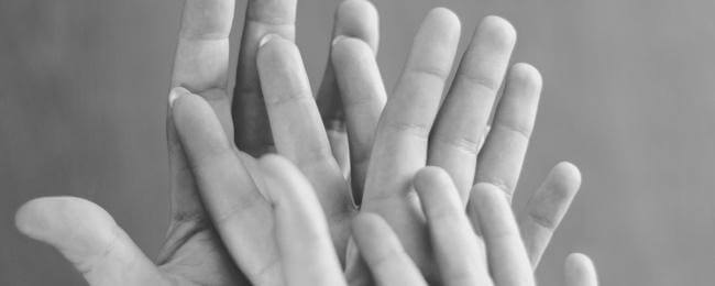 Childrens' and adults' hands, one in the other